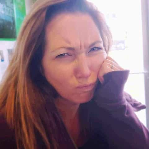 Woman experiencing a perimenopause hot flash, expressing frustration and discomfort